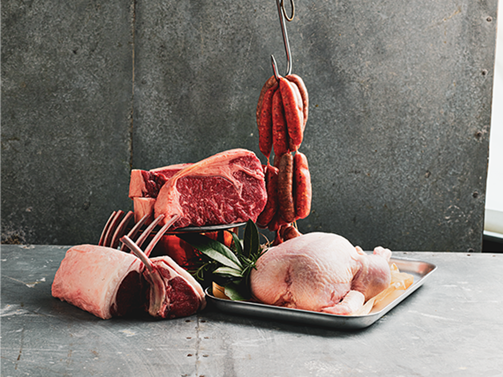 Cuts of beef, lamb racks, sausages, and whole chicken displayed in the Sydney Royal Branded Meat Show.