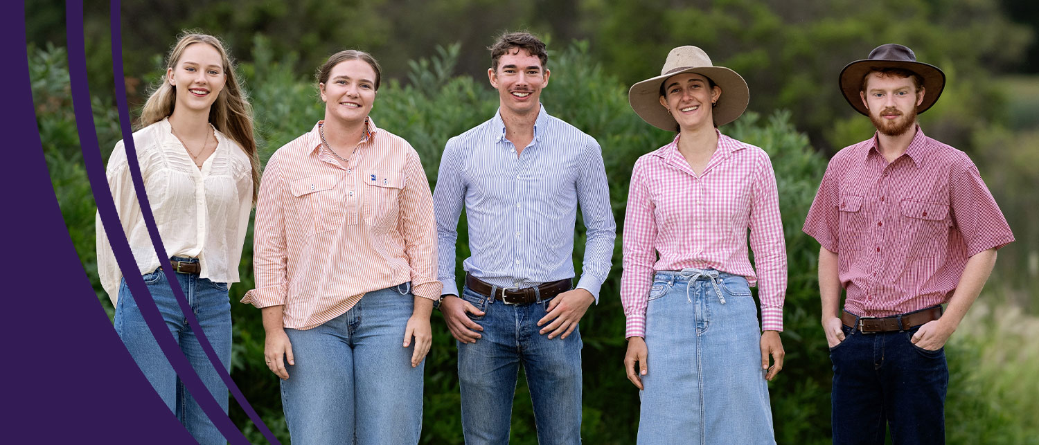 Five recipients of the RAS Foundation Rural Scholarship standing side by side in rural setting, wearing casual work wear and hats.
