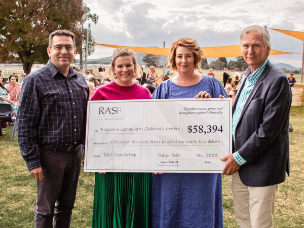 Four RASF Community Futures Grant recipients standing outdoors, holding an oversized cheque for Eugowra Community Children’s Centre.