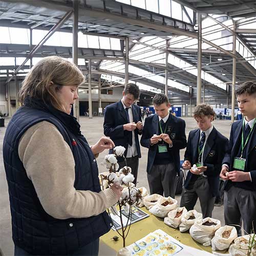 Students assessing agricultural samples at a display table during hands-on judging activity, led by a recipient of the RAS Foundation Master of Teaching Scholarship.