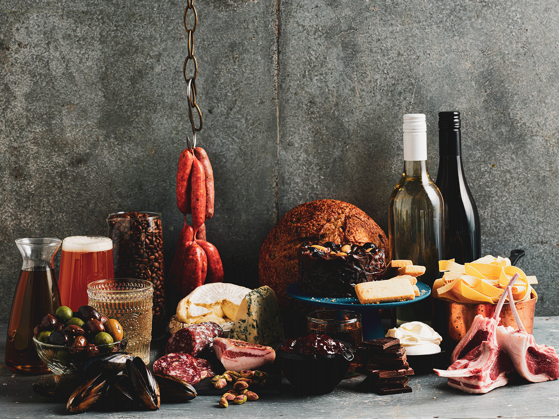 Charcuterie display of gourmet food and drinks including wine, cheese, coffee, olives and bread for the 19th President's Medal Competition.