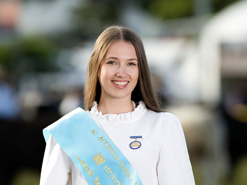 Headshot of 2026 Young Woman runner-up Madison Luke, a light brunette woman with straight hair, wearing a white shirt an light blue sash.
