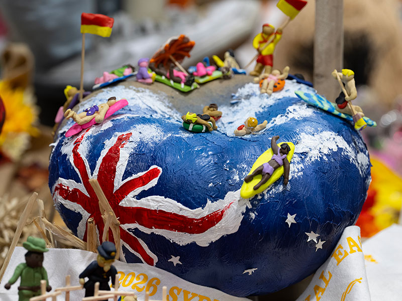A pumpkin with the Australian flag creatively painted and sculptured with beach surfers and lifeguards, on display at the Great Backyard Pumpkin Challenge.